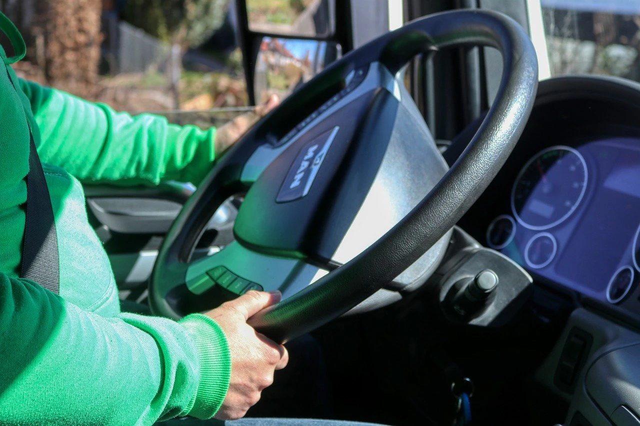 Driver's hands on a steering wheel